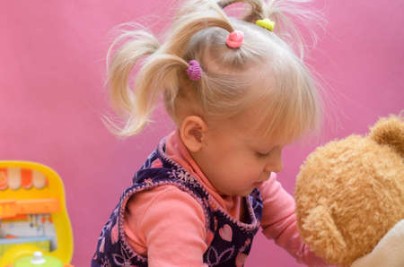 The little girl is playing with any soft toysの写真素材