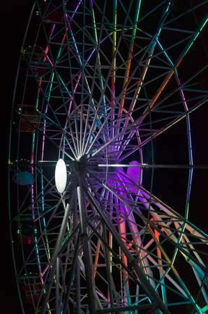 Attraction in the form of a Ferris wheel in the dark with beautiful lighting.の写真素材