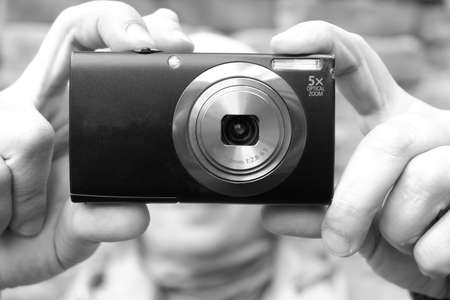 A girl near a brick wall shoots with the camera. St. Veronicas Day Photographers Day .の写真素材