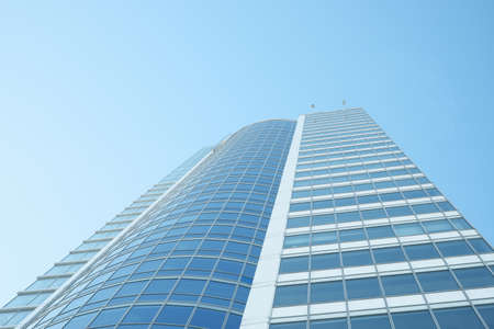Corporate buildings from the bottom of the camera against the blue sky.のeditorial素材