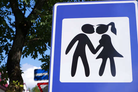 The road sign is a place for kisses in blue with the image of silhouettes of opposite sexes.の写真素材