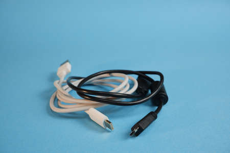 White and black wires with different usb interfaces on a blue background.