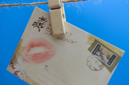 Envelope with a kiss on the rope on a blue background.の写真素材