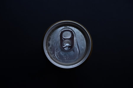 Beer can from above on a dark background.の写真素材