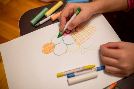 Draw with colored pencils on a white sheet of paper.の写真素材