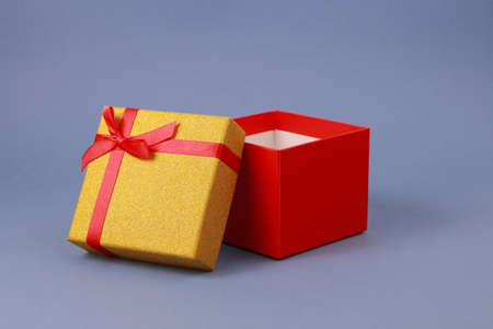 Open red gift box with lid on background of blue paper. flat plan, space for subject. Layout, holiday concept.の写真素材