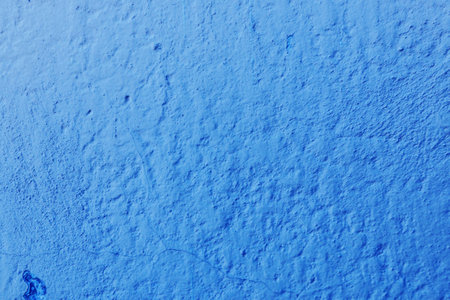 Texture from a wall with old blue paint damaged by time. Abstract background for design, place for text.の写真素材