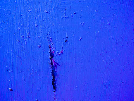 Big scratch on the wall with blue paint.Abstract surface from damaged old blue paint.の写真素材