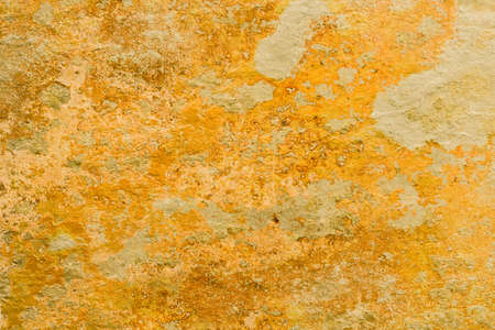 Old peeling damaged Yellow wall with paint stains and scratches.の写真素材