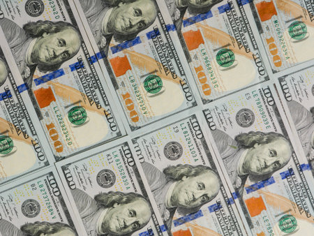 Dollars lying evenly in a row as a top view.