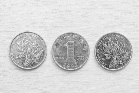 White metal one yuan coins on a white background. Yuan coins with different sides.