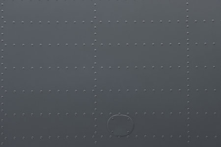 Iron panel of airplane. Texture and background of old metal surface of aircraft fuselage with rivets