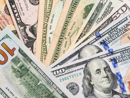 Group of money stack of 100 US dollars banknotes a lot of the background