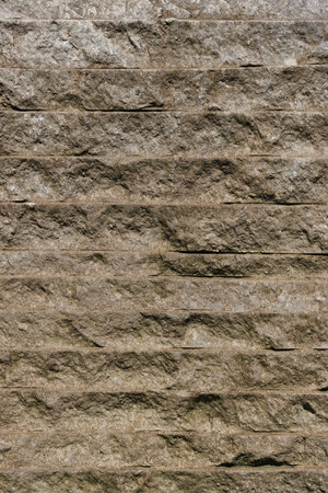 Texture of a stone wall with horizontal stripes. Texture from a wall surface damaged by weather.
