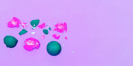 Bright green and dark orange shells on a pastel paper background. Easter background. Happy easter concept. Multicolored decorative eggshell on a blue background.の写真素材