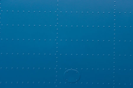 Riveted metal from an aircraft. Abstract blue metal background with studs.の写真素材
