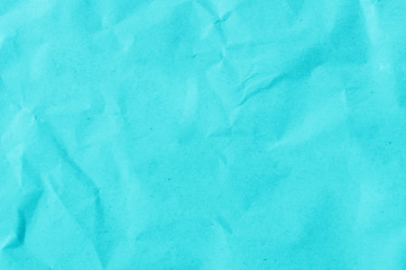 Cardboard background made of natural crumpled paper in blue.の写真素材