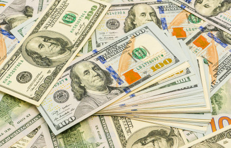 Pile of new design US dollar bills as background. Top view point. 100 Dollars with a portrait of the President.の写真素材