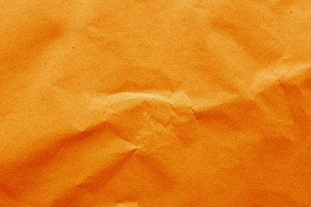 Cardboard background from natural crumpled paper in orange color.....の写真素材