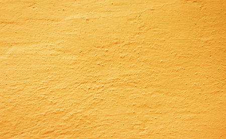 Fragment of a wall painted with orange paint. Not a flat wall.....の写真素材