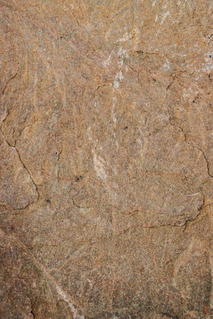 The texture of the granite stone surface in close-up. Abstract background of granite wall close-up.の写真素材
