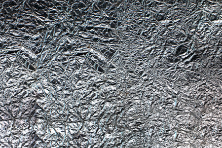 Abstract background of white silver foil closeup.の写真素材