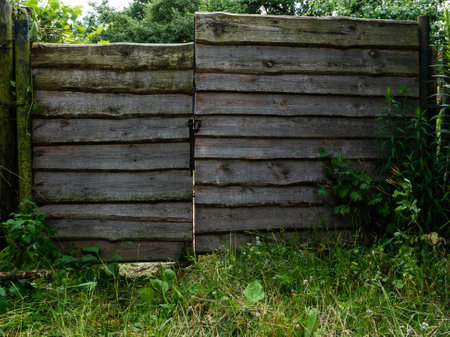 Wicket and fence against green grass. Plank fence in the garden.の写真素材