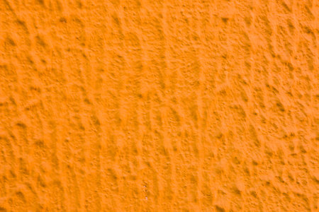 Relief texture of orange paint on the wall.の写真素材