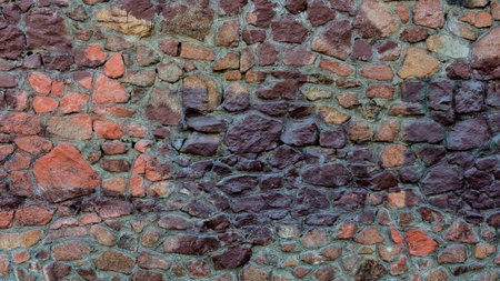 A wall of red, purple stone.の写真素材