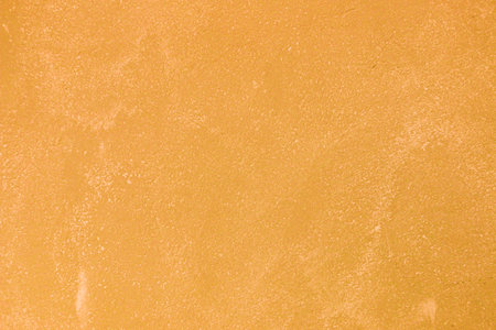 Texture of old orange plaster damaged by time.の写真素材
