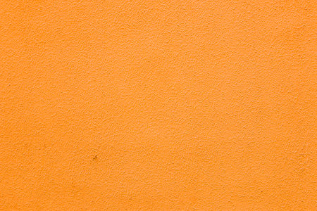 A wall with worn orange poster.の写真素材