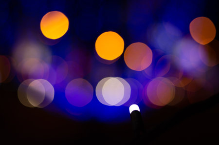 Light Bokeh Background. Blurred image of blue and orange lights at night on a blurry background.の写真素材