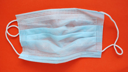 Medical face mask on red background. Coronavirus outbreak concept.