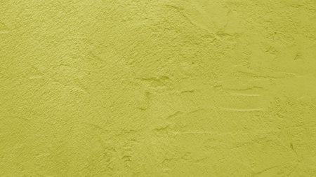 Old shabby yellow-green plaster close-up.の写真素材