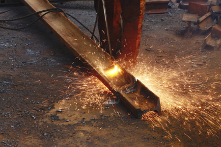 Cutting an old metal rail with a gas burner flame, close-up. Autogen operation.の写真素材