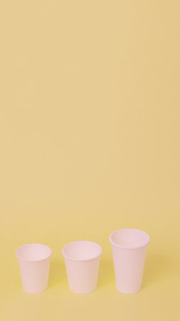 Take away a cup of coffee on orange paper background.