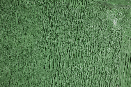 Green cemet wall. Texture of vertical plaster stripes on a wall.