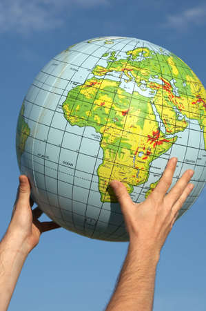 they are hands with a ball of the worldの写真素材