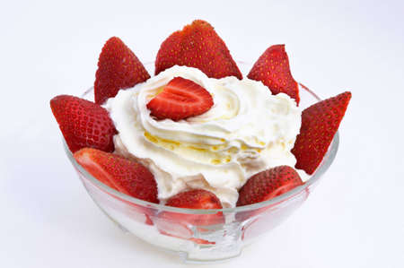 a red strawberry on white creamの写真素材