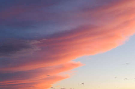 red photo of a dusk with the sky and clouds