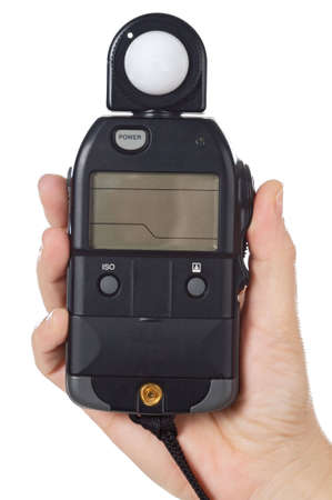 hands with a photometer to measure the light in the sceneの写真素材