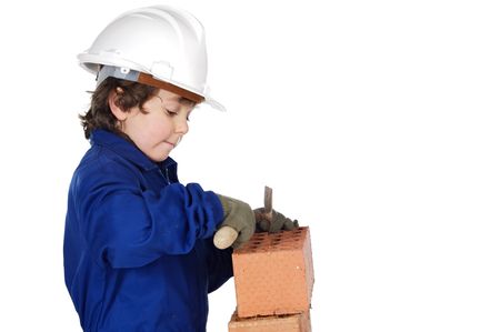 adorable future builder constructing a brick wall a over white backgroundの写真素材