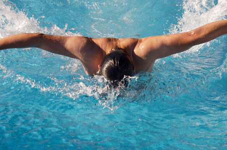 photo of a swimmer doing spring in swimming poolの写真素材
