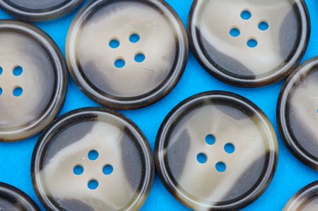 group of buttons with four holes on a blue backgroundの写真素材
