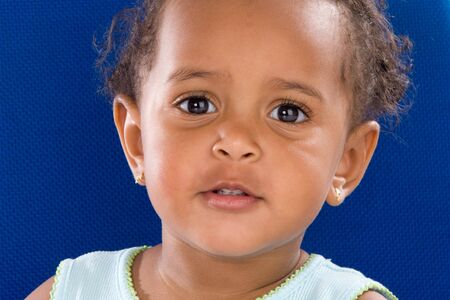 Adorable  smiling a over blue backgroundの写真素材