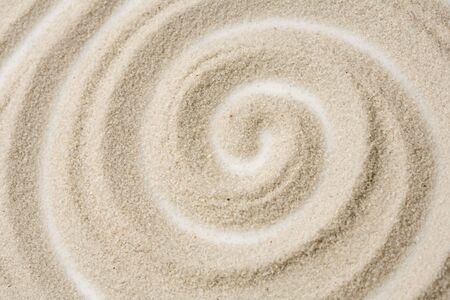 Photo of spiral pattern in the sandの写真素材