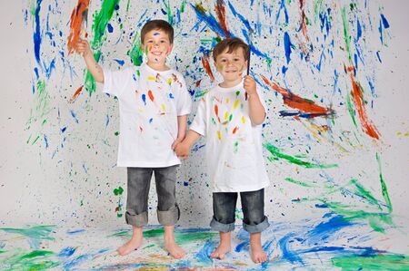 Children playing with painting with the background paintedの写真素材