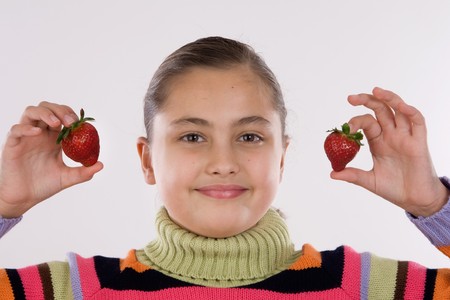Photo of cute girl holding two strawberriesの写真素材