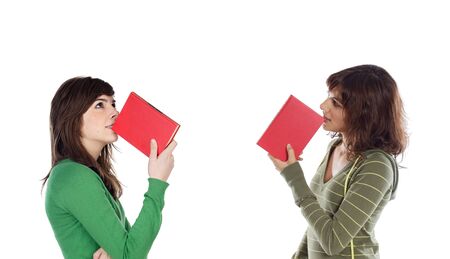 Two young girls thinking with books isolated over white