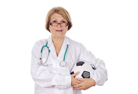 Female doctor holding soccer ball over white backgroundの写真素材